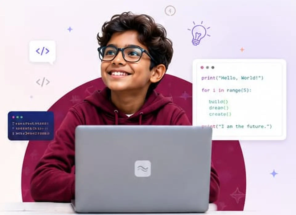 A smiling student coding on a laptop