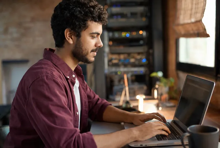 A learner typing commands in a terminal on a laptop